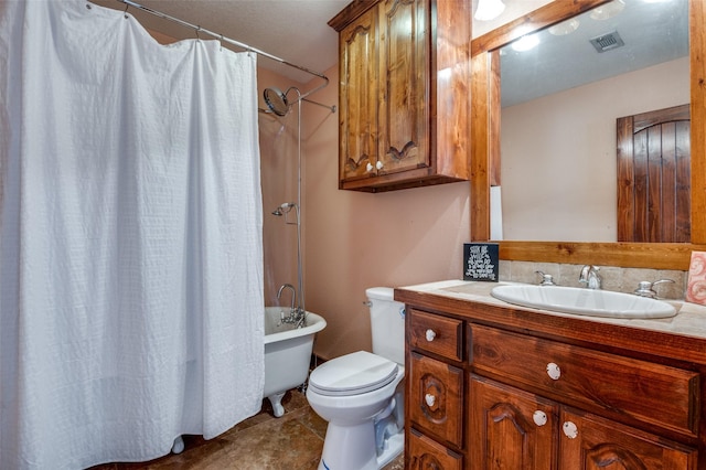 bathroom featuring vanity, tile patterned flooring, and toilet