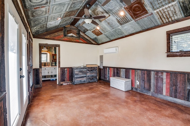 interior space featuring lofted ceiling, a wall mounted AC, concrete floors, electric panel, and ceiling fan