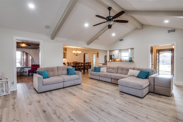 living room with ceiling fan with notable chandelier, light hardwood / wood-style flooring, high vaulted ceiling, and beamed ceiling