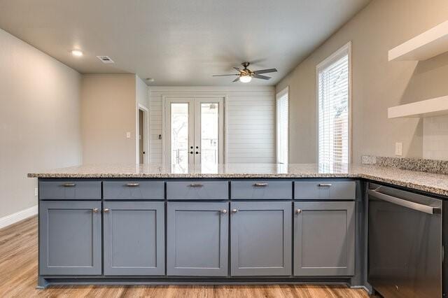 kitchen featuring gray cabinetry, light wood-type flooring, dishwasher, kitchen peninsula, and light stone countertops