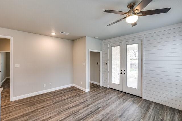 foyer featuring wood-type flooring, french doors, and ceiling fan