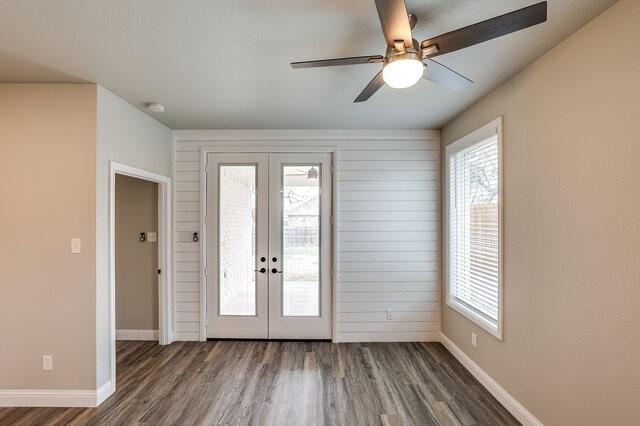 interior space featuring french doors, dark wood-type flooring, and a wealth of natural light