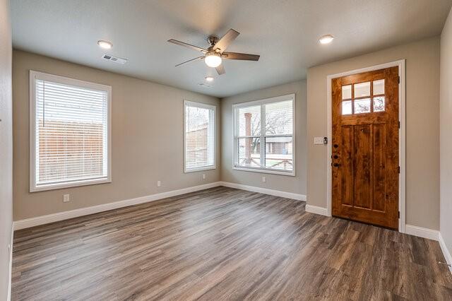 entryway with dark wood-type flooring and ceiling fan