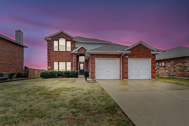 traditional-style home with brick siding, a front lawn, fence, driveway, and an attached garage