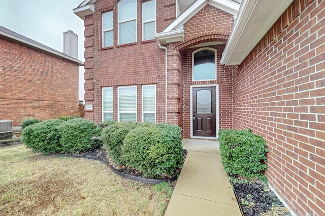 property entrance with brick siding