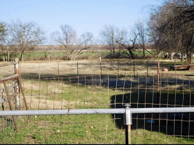view of yard featuring fence and a rural view