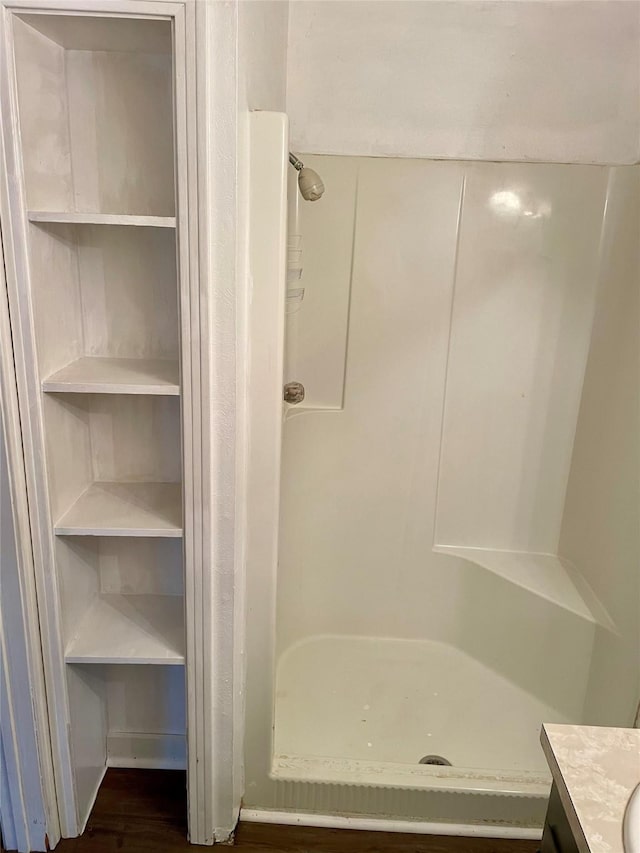 full bathroom with a stall shower and vanity