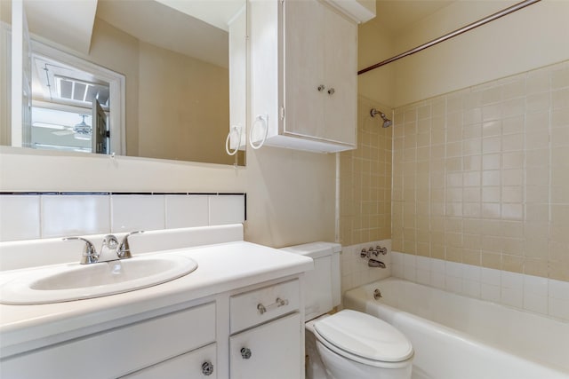 full bathroom with vanity, toilet, and tiled shower / bath