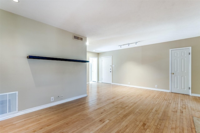 empty room with light hardwood / wood-style floors