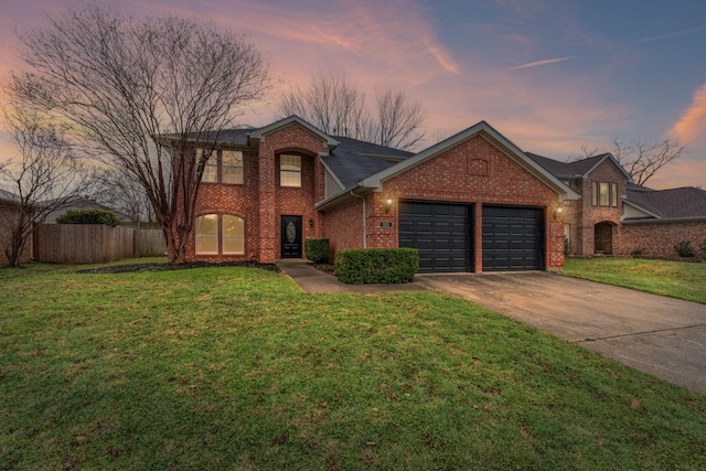 view of property featuring a yard and a garage