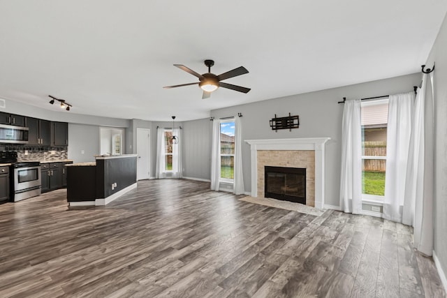 unfurnished living room with ceiling fan and hardwood / wood-style floors