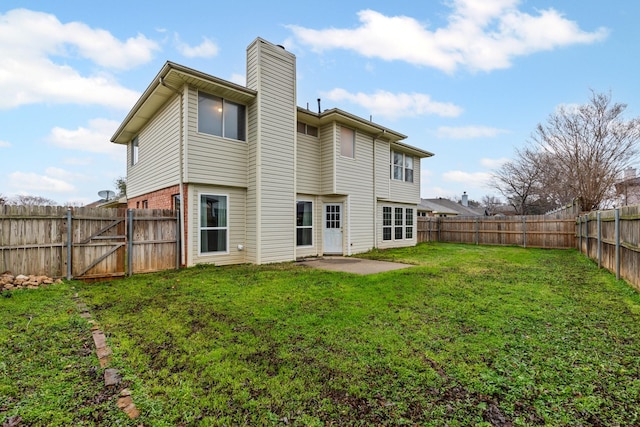 rear view of house featuring a yard and a patio area