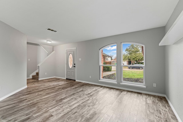 unfurnished living room featuring wood-type flooring