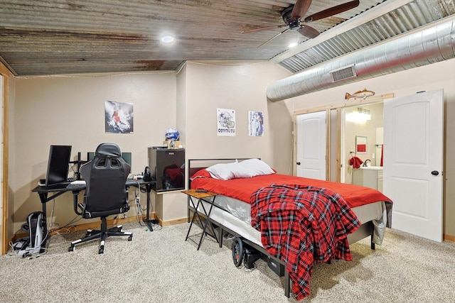 carpeted bedroom featuring connected bathroom, vaulted ceiling, and ceiling fan