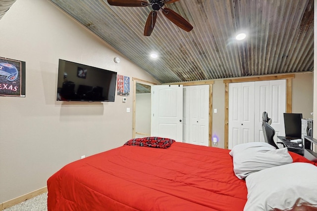 carpeted bedroom featuring lofted ceiling, ceiling fan, wooden ceiling, and multiple closets