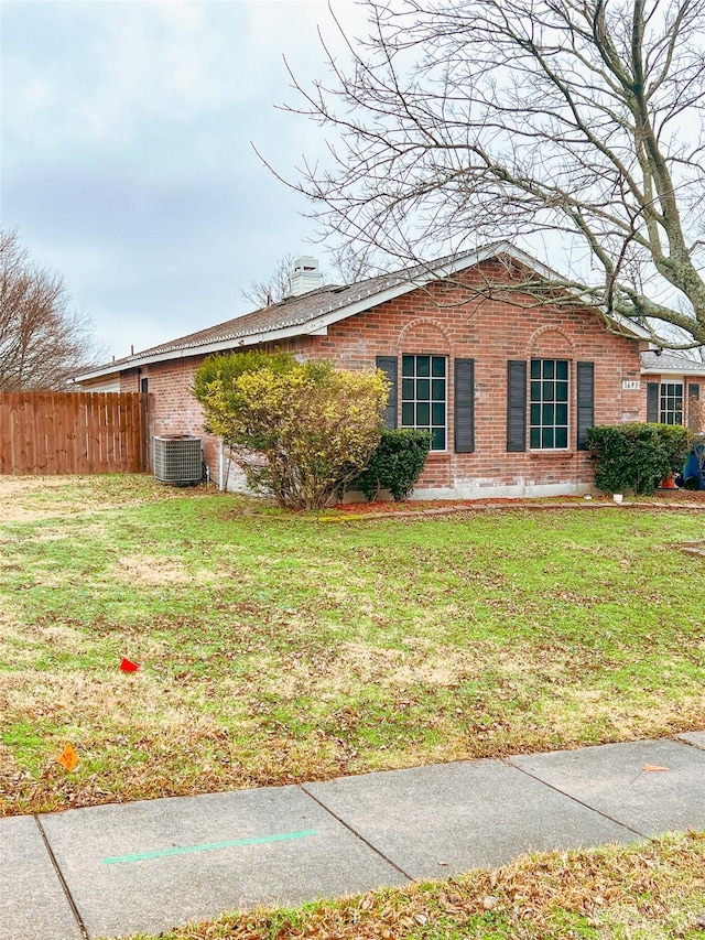 view of home's exterior with a lawn and central air condition unit