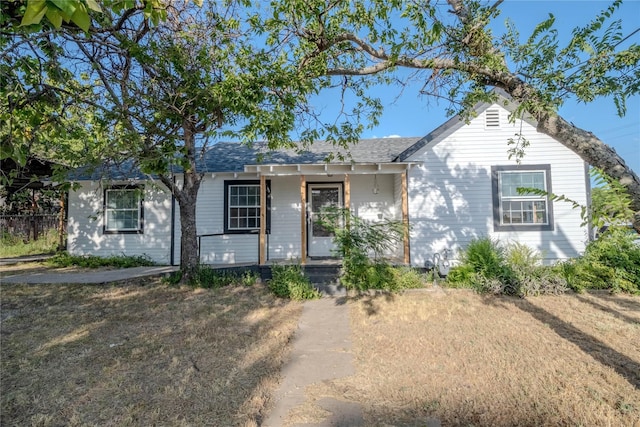 ranch-style house featuring a porch and a front yard