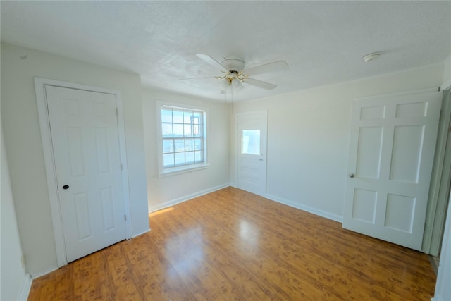 unfurnished bedroom featuring hardwood / wood-style floors and ceiling fan