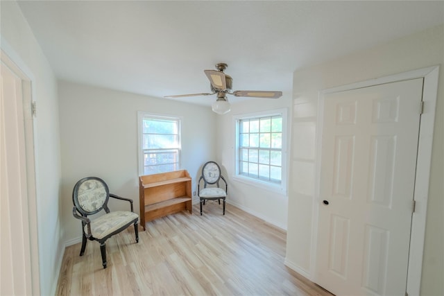 living area featuring ceiling fan and light hardwood / wood-style floors