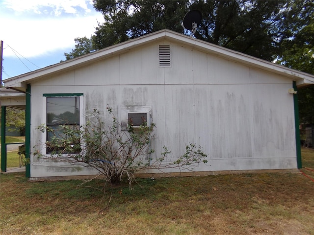 view of side of property with a lawn