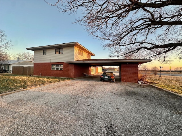 property exterior at dusk with a carport