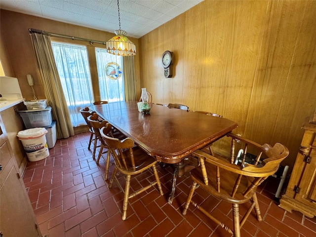 dining space with wood walls