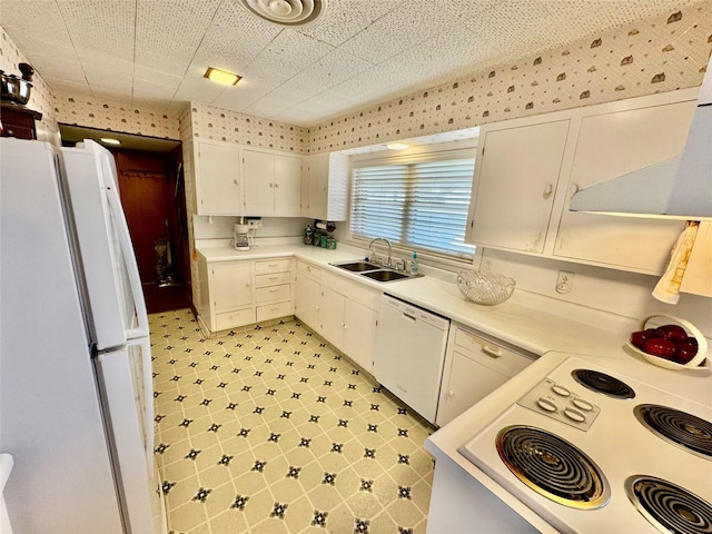 kitchen featuring white cabinetry, sink, and white appliances