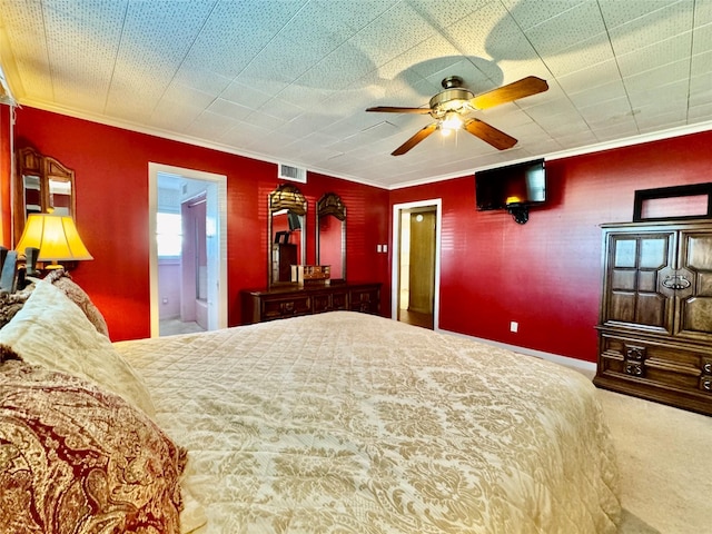 bedroom with crown molding, ceiling fan, ensuite bathroom, and carpet flooring