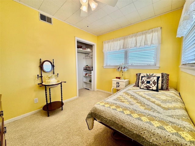 carpeted bedroom with a closet and ceiling fan