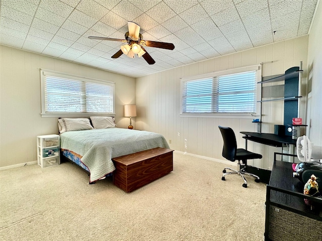 carpeted bedroom with multiple windows and ceiling fan