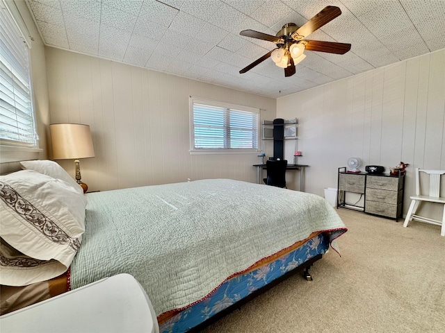 carpeted bedroom with multiple windows and ceiling fan