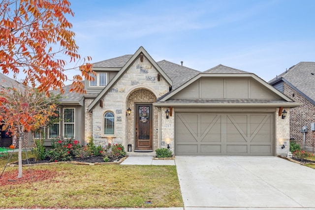 view of front of home with a garage and a front yard