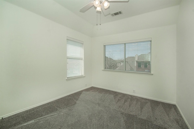 spare room with ceiling fan and carpet