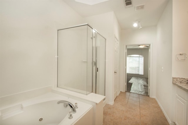 bathroom with vanity, tile patterned flooring, and plus walk in shower