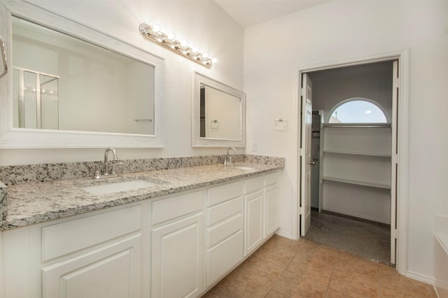 bathroom featuring tile patterned flooring and vanity