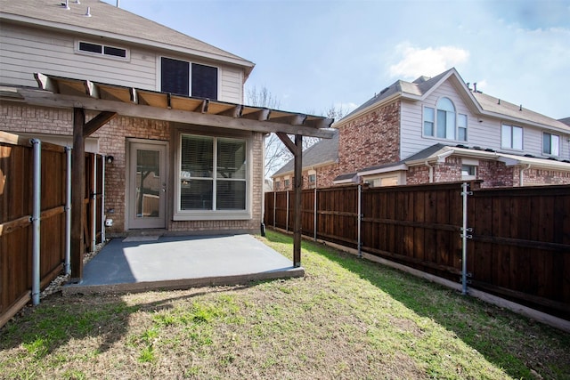 back of property featuring a yard, a pergola, and a patio