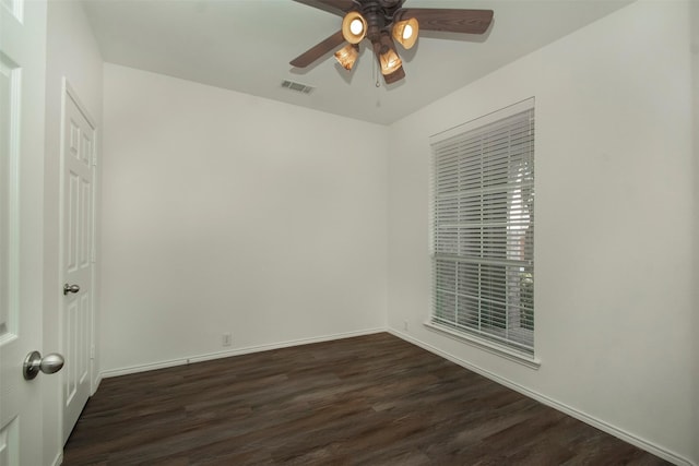 spare room with ceiling fan and dark hardwood / wood-style flooring