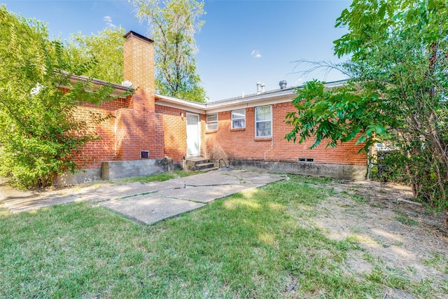 rear view of house with a lawn