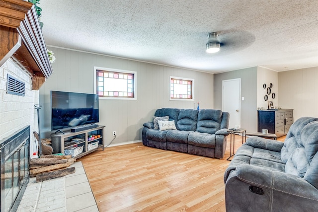 living room with hardwood / wood-style floors and a textured ceiling