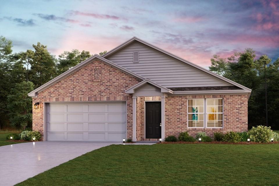 view of front of home with a garage and a lawn