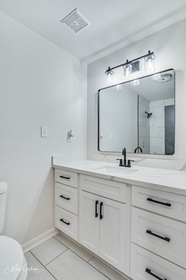 full bath with toilet, vanity, visible vents, marble finish floor, and a tile shower