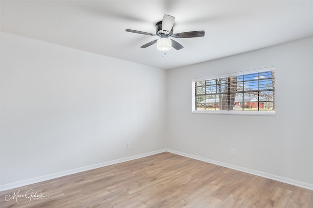 empty room with baseboards, ceiling fan, and light wood-style floors