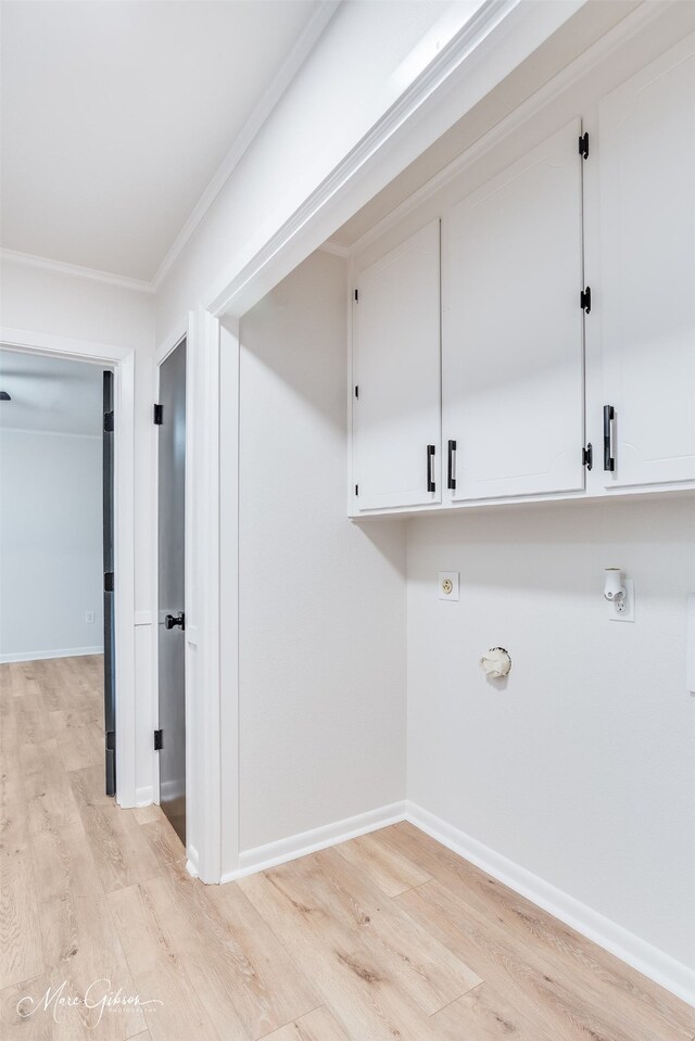 laundry room with cabinet space, baseboards, light wood-style flooring, ornamental molding, and hookup for an electric dryer