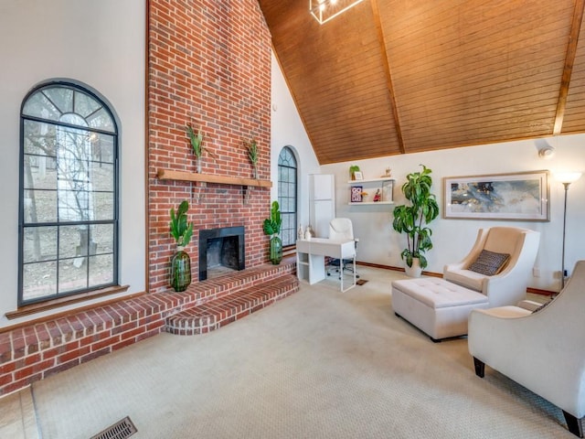 living room featuring wood ceiling, a brick fireplace, light carpet, and a wealth of natural light