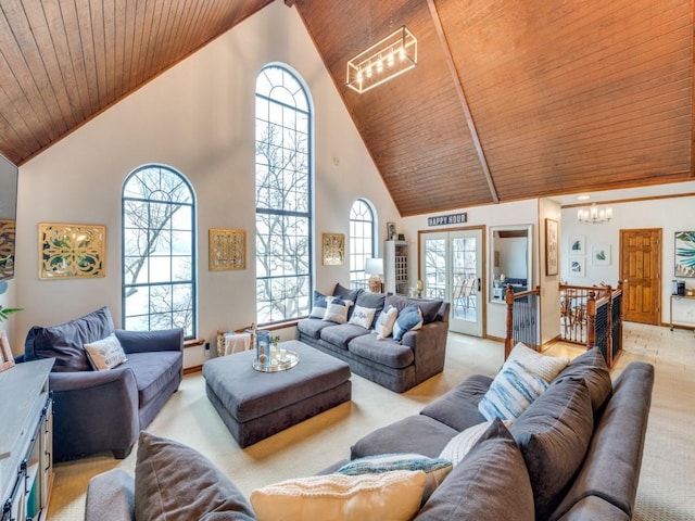 carpeted living room featuring high vaulted ceiling, a healthy amount of sunlight, a notable chandelier, and wood ceiling