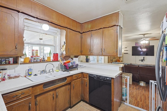 kitchen featuring sink, a textured ceiling, dishwasher, ceiling fan, and decorative backsplash