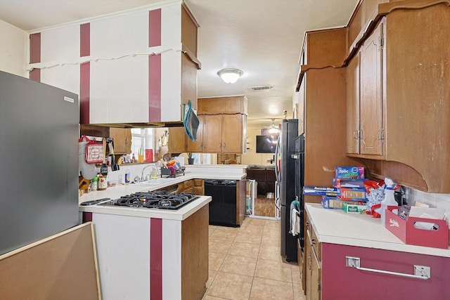 kitchen with sink, stainless steel appliances, and light tile patterned flooring