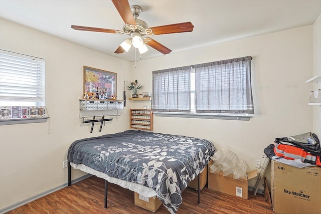 bedroom with dark wood-type flooring and ceiling fan