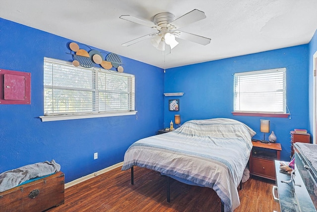 bedroom with ceiling fan and dark wood-type flooring