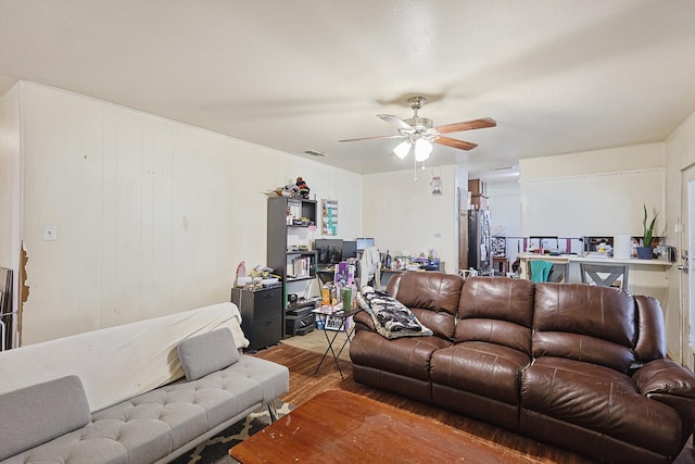 living room featuring ceiling fan and wood-type flooring